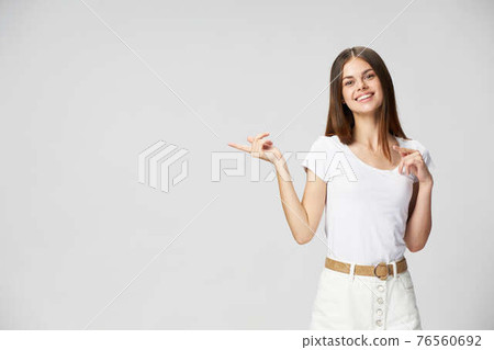woman in light clothes shows thumb to the side and cropped view of Copy Space woman in light clothes shows thumb to the side and cropped view of Copy Space 76560692