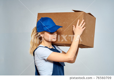 Woman in working uniform box packing service lifestyle Woman in working uniform box packing service lifestyle 76560709