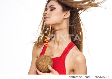 Cheerful woman coconut cocktail red swimsuit summer vacation lifestyle Cheerful woman coconut cocktail red swimsuit summer vacation lifestyle 76560722