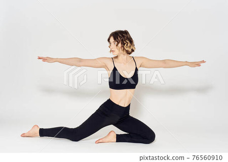 woman in dark clothes sitting on the floor and meditation exercises for legs leggings woman in dark clothes sitting on the floor and meditation exercises for legs leggings 76560910