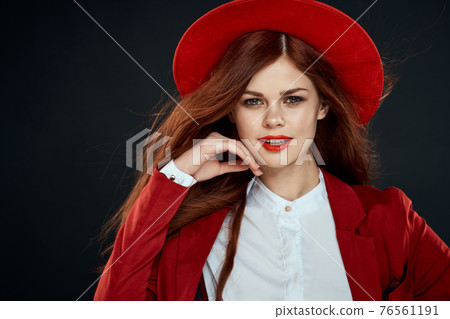 Pretty woman with red lips hat on her head jacket elegant style charm dark isolated background Pretty woman with red lips hat on her head jacket elegant style charm dark isolated background 76561191