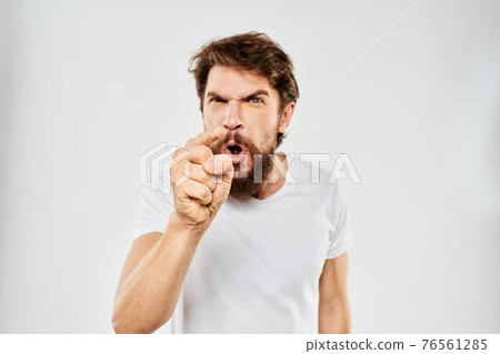 emotional man with a beard gesturing with his hands close-up studio aggression 76561285