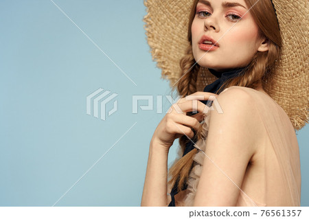 Romantic girl in a straw hat on a gray background and a beige sundress black ribbon emotions model 76561357