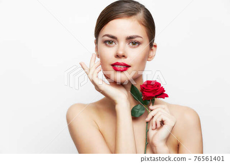 Portrait of woman with rose Runs his hand over his face, bare shoulders red lips  76561401
