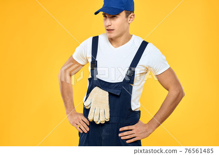 Man in working uniform emotions rendering service delivery service yellow background Man in working uniform emotions rendering service delivery service yellow background 76561485