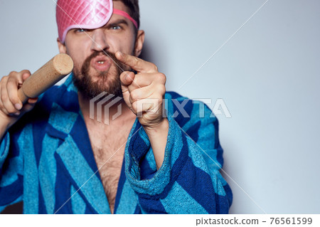 a man in a pink sleep mask holds a rolling pin in his hands and emotions energy aggression model blue robe 76561599