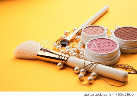 Eyeshadows on a yellow background professional cosmetics makeup brushes soft sponge fashion glasses Eyeshadows on a yellow background professional cosmetics makeup brushes soft sponge fashion glasses 76561600