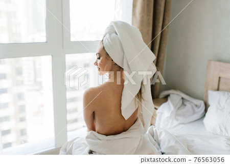 Beautiful young healthy woman relaxing in a robe, hotes, room, spa salon 76563056