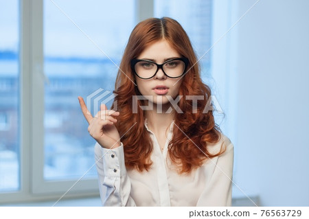 pretty red-haired woman in shirt office tin plate with hands Copy Space pretty red-haired woman in shirt office tin plate with hands Copy Space 76563729