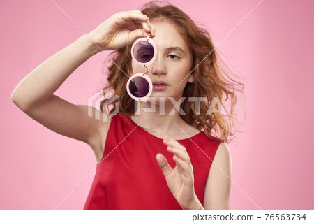 girl with curly hair sunglasses childhood joy pink background 76563734