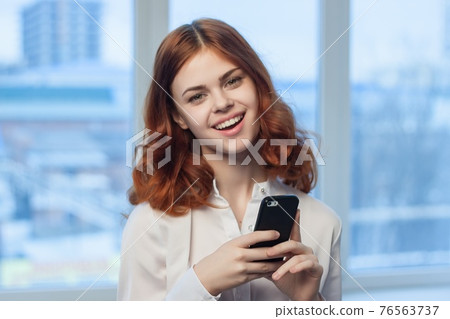 pretty woman in shirt with phone in hand technology professional official pretty woman in shirt with phone in hand technology professional official 76563737