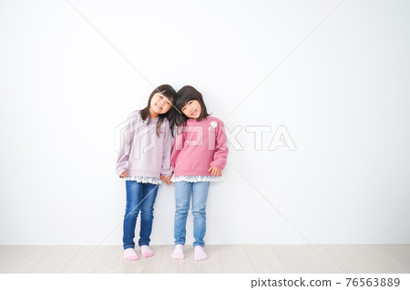 Little girls playing happily 76563889