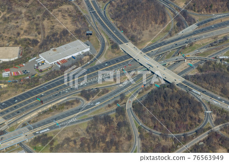 High above highways, interchanges the roads on interstate takes you on a fast transportation highway in Newark New Jersey US drone view 76563949