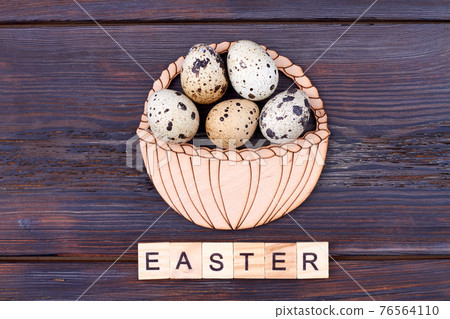 Vertical shot basket of quail eggs. 76564110
