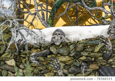 Decorative skeleton crawls out of a stone wall, house with skulls, house with devils in the village of Ratomka, a house with forged decorations Decorative skeleton crawls out of a stone wall, house with skulls, house with devils in the village of Ratomka, a house with forged decorations 76566553
