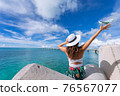 Woman waving towards the plane 76567077