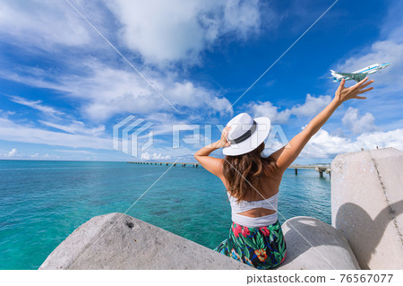 Woman waving towards the plane Woman waving towards the plane 76567077