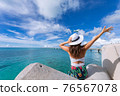 Woman waving towards the plane 76567078