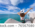 Woman waving towards the plane 76567080