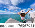 Woman waving towards the plane 76567081