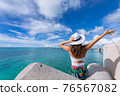 Woman waving towards the plane 76567082