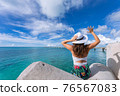 Woman waving towards the plane 76567083