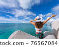 Woman waving towards the plane 76567084