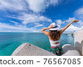 Woman waving towards the plane 76567085