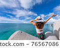 Woman waving towards the plane 76567086