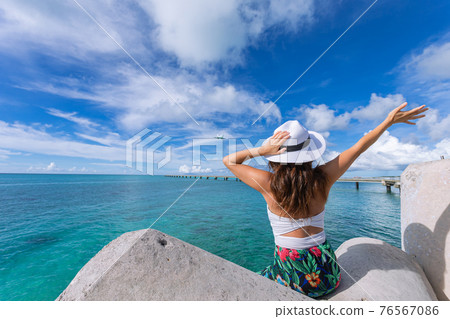 Woman waving towards the plane Woman waving towards the plane 76567086