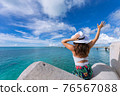 Woman waving towards the plane 76567088