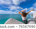 Woman waving towards the plane 76567090