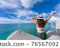 Woman waving towards the plane 76567092