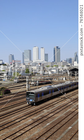 Skyscrapers around Nagoya Station and Aonami Line trains seen from the Koganekosen Bridge in Nagoya City 76568021