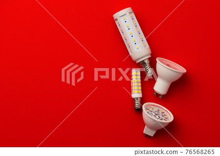 LED light bulbs on red background top view 76568265