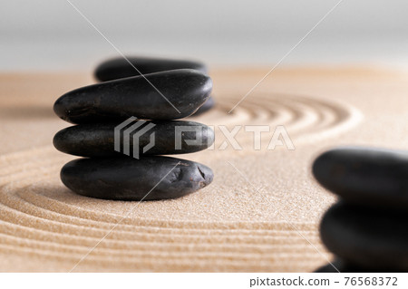 Japanese zen garden with stone in raked sand Japanese zen garden with stone in raked sand 76568372