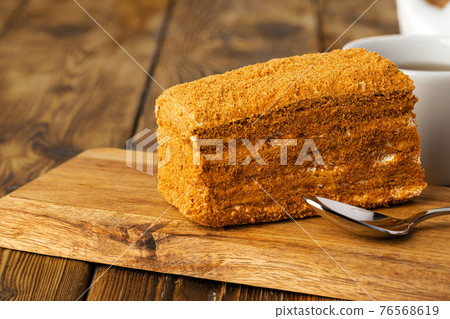 Piece of honey cake on kitchen table Piece of honey cake on kitchen table 76568619