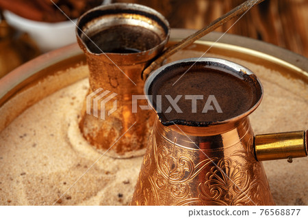 Turkish coffee in cezve on the sand 76568877