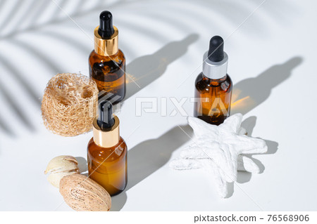 Skincare products containers on a white background with creative shadows Skincare products containers on a white background with creative shadows 76568906