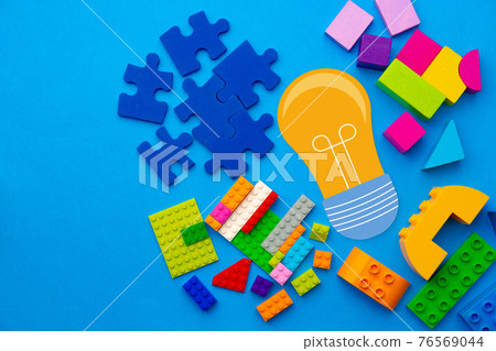 Ideas concept with light bulb and toy constructor details 76569044