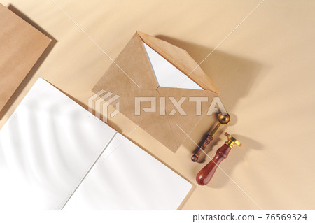 Craft paper letter on beige background top view Craft paper letter on beige background top view 76569324