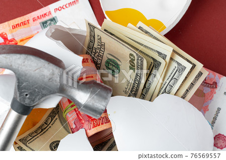 Multicurrency basket concept. Piggy bank with banknotes of US dollars and russian roubles Multicurrency basket concept. Piggy bank with banknotes of US dollars and russian roubles 76569557