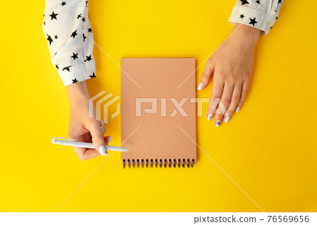 To do list. Top view of female hands writing in notebook To do list. Top view of female hands writing in notebook 76569656