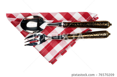 Set of cutlery on red cloth napkin on white background 76570209