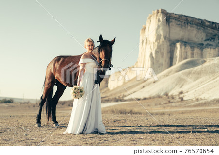 Portrait of a beautiful bride with horse 76570654