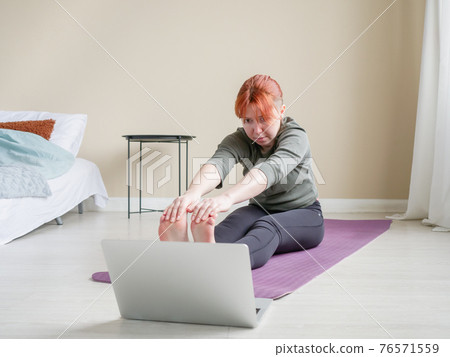 Online training using laptop. Girl doing Online training using laptop. Girl doing 76571559