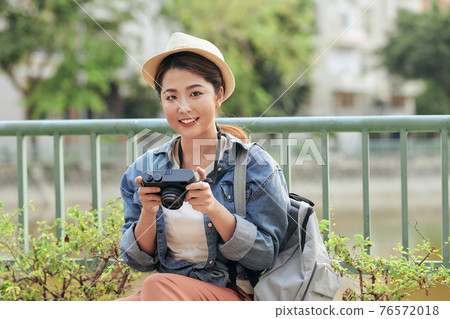 Photo of young tourist girl exploring streets. Photo of young tourist girl exploring streets. 76572018
