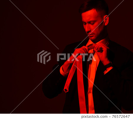 Portrait of young focused businessman in official Portrait of young focused businessman in official 76572647