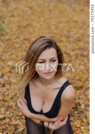 Beautiful woman portrait in forest in autumn. Beautiful woman portrait in forest in autumn. 76573458