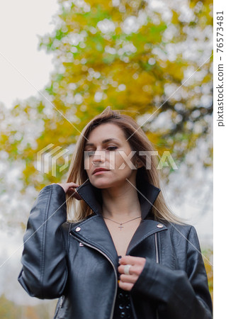 Beautiful woman portrait in forest in autumn. 76573481